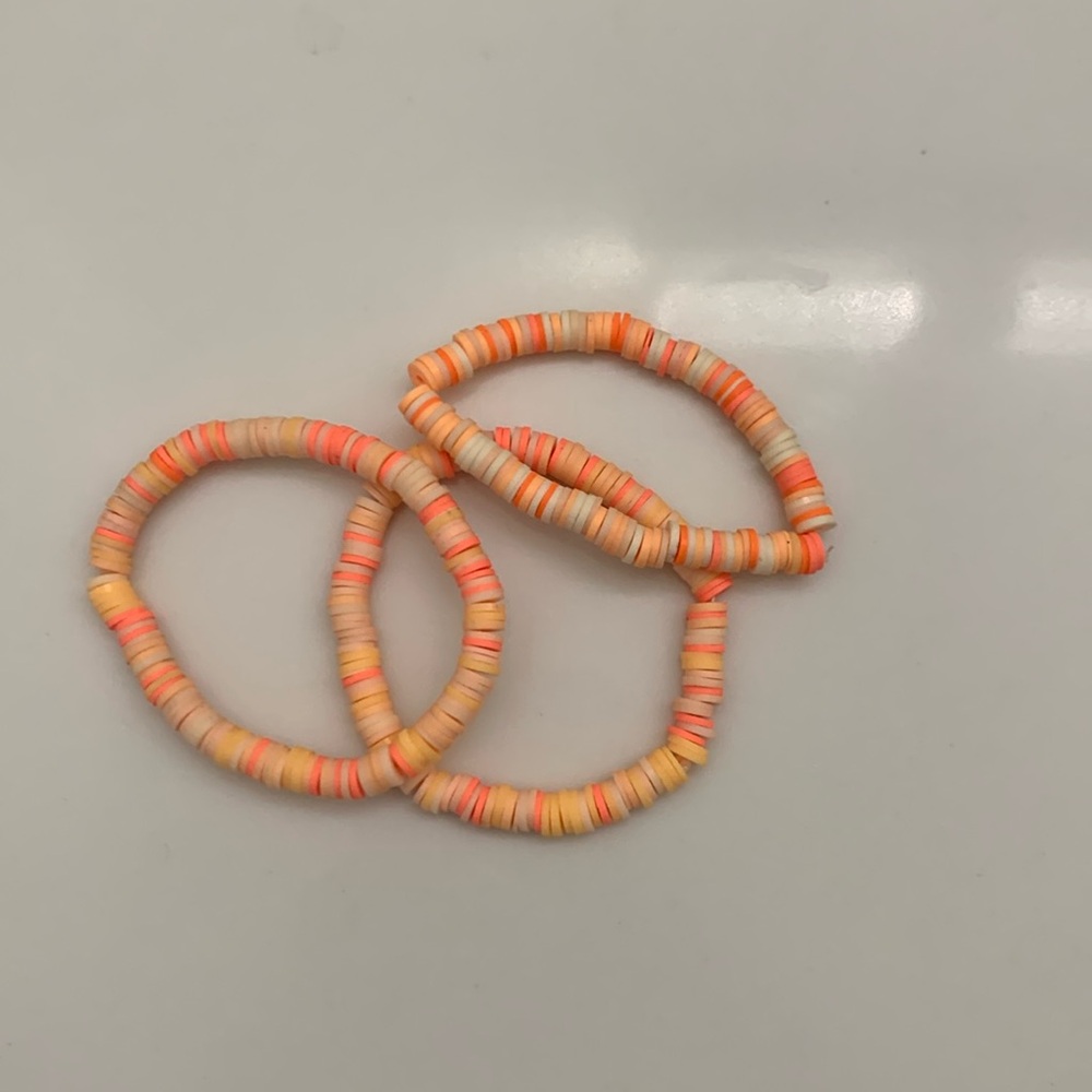 Three orange bracelets